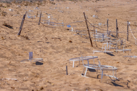 The famous landmark of 'Turtle Bay' in Paphos, Cyprus. Cages set out to protect where the turtles have laid their eggs in the sand and to stop predators and humans destroying them.の写真素材