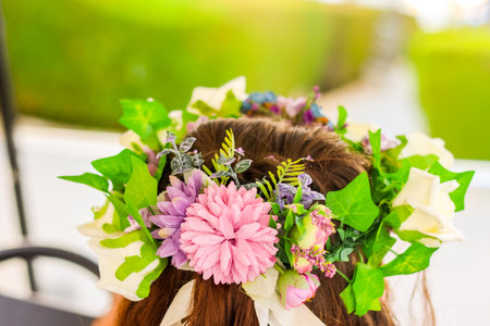 A beautiful wedding head wreath on top of the Bridesmaid's head. Full stunning roses and flowers.の写真素材