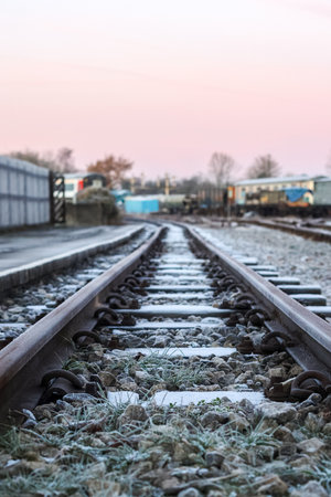 A view looking down at frosty railway tracks, used by diesel and electric freight and passenger trains to get to and from their destinations.の写真素材