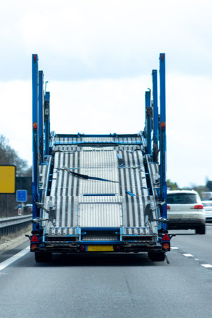 A large vehicle transporter truck, traveling along a motorway in the United Kingdom.の写真素材