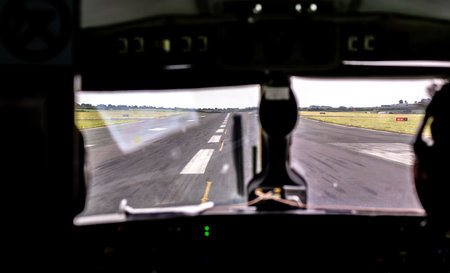 An aircraft landing or taking off from an airport tarmac runway.