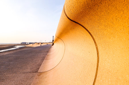 Some people like to visit or live in Blackpool, UK, so they can walk and enjoy the sea air along the coast.の写真素材