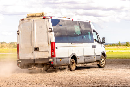 An old bus / van used as a shuttle bus to take people or passengers from one location to another.
