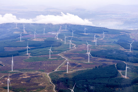 A view from above of one of the many wind farms that surround the United Kingdom bringing free...