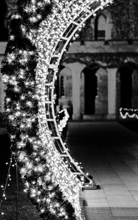 A large curved archway decorated with Christmas lights.