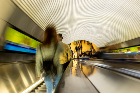 Escalators provide quick and easy access to local commuters and tourists up and down into the London Underground tunnels.の写真素材