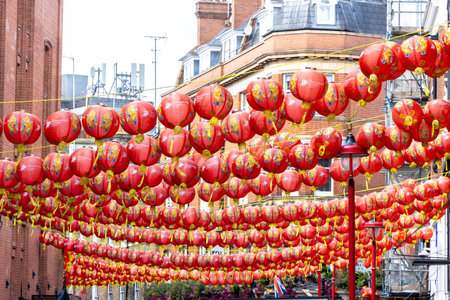 Beautiful orange Chinese lanterns strewn across the street to decorate the area for tourists and locals to enjoy.の写真素材