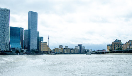 The River Thames, in London, is one of the most famous rivers in the World. Here seen a view looking along with various landmarks and buildings that surround it.の写真素材
