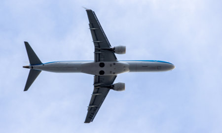 A passenger aircraft passing overhead as it either comes into land or has just taken off from an airport.の写真素材