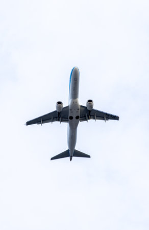 A passenger aircraft passing overhead as it either comes into land or has just taken off from an airport.の写真素材