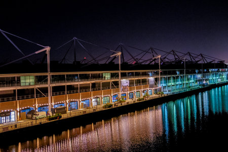The Royal Victoria Docks surrounded by homes, cranes, businesses, hotels and activities. Seen here at night.の写真素材