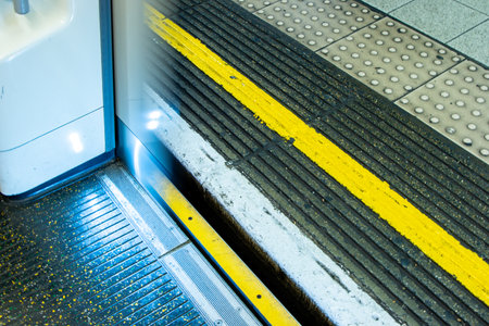 A London Underground train either arriving or departing as the doors open or close ready to pick up or drop off it's passengers.の写真素材