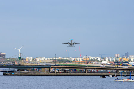A large commercial aircraft taking off, flying over a body of water.の写真素材