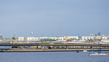 A large commercial aircraft coming into land at London City Airport, in the United Kingdom.の写真素材