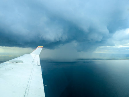 Bad Weather clouds seen from an aircraft approaching To Bring Heavy Rain And/Or Strong Winds. Typically dark or large clouds indicate heavy weather is inbound or passing by.の写真素材