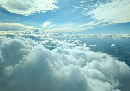 Air travel being the fastest way to get around the globe, here seen from a passenger window as the aircraft flies above the clouds.の写真素材