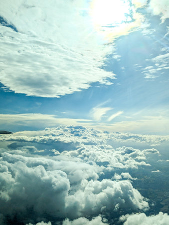 Air travel being the fastest way to get around the globe, here seen from a passenger window as the aircraft flies above the clouds.の写真素材