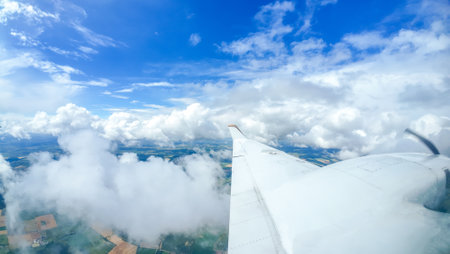 Air travel being the fastest way to get around the globe, here seen from a passenger window as the aircraft flies above the clouds.の写真素材