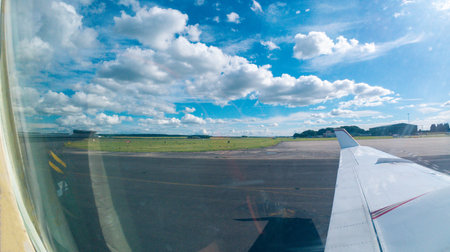 An aircraft taxiing through an airport's taxiway system to it's parking spot/stand or to the runway for departure.の写真素材