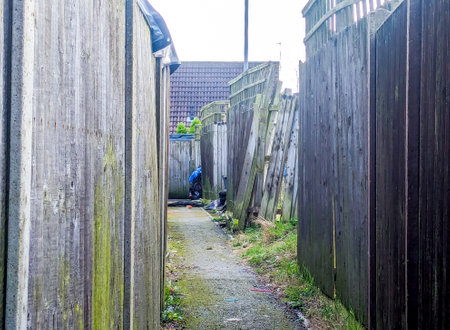 A long narrow alleyway for people to pass through usually found between buildings / property...