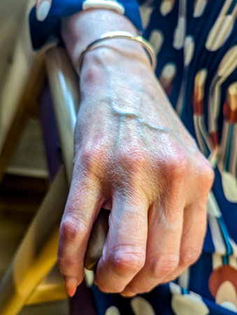 An adult female hand seen close up with the veins and skin that has lasted for many years.の写真素材