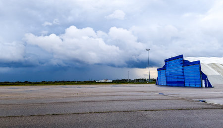 A large airfield with bad weather clouds seen approaching. Heavy rain and winds expected.の写真素材