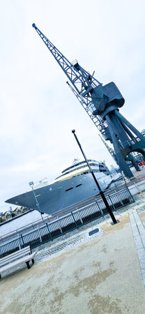 A large superyacht docked at a pier. Often used to take people on holidays and trips across the world.の写真素材