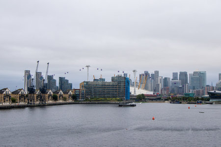 The Royal Victoria Docks surrounded by homes, cranes, businesses, hotels and activities.の写真素材