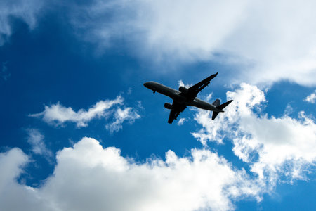 A passenger aircraft passing overhead as it either comes into land or has just taken off from an airport.の写真素材