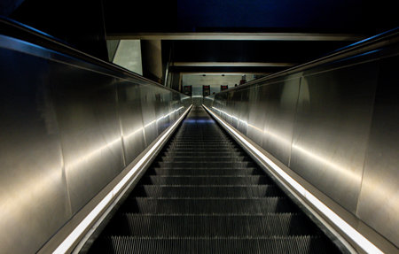 Escalators provide quick and easy access to local commuters and tourists up and down into the London Underground tunnels.の写真素材