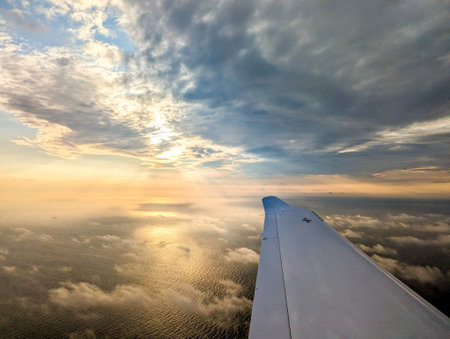 Air travel being the fastest way to get around the globe, here seen from a passenger window as the aircraft flies above the clouds.の写真素材