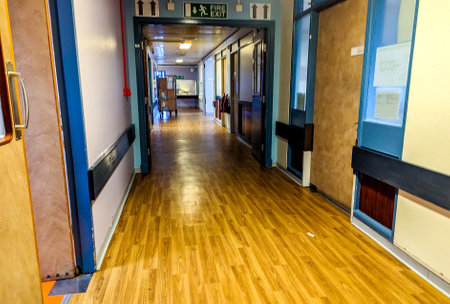 Patients and staff walk the corridors of a hospital to get to and from their appointment(s) or to visit their friends and family.の写真素材