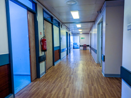 Patients and staff walk the corridors of a hospital to get to and from their appointment(s) or to visit their friends and family.の写真素材