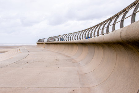 A sea wall designed, built and put in place to prevent stormy weather breaching the walls and damaging property inland.の写真素材