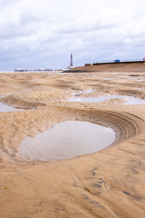 Small pools of water are created in small pits along the coast of a large beach, nature's creations with various weathers and tides.の写真素材