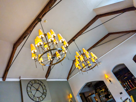 Beautiful ceiling lights hanging from the roof of a nice restaurant illuminating the tables below for customers to enjoy.の写真素材