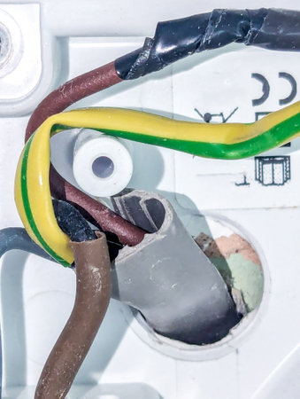 A close up view inside an electric socket component, wired up to supply power to a plug or an appliance of some type.の写真素材