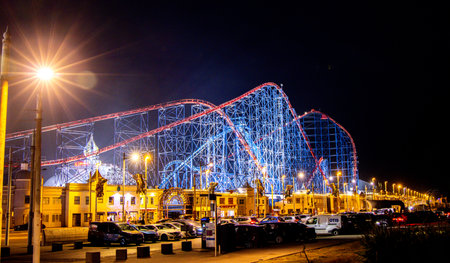 A rollercoaster is one of the best adrenaline junkie activities to do. Here seen a large rollercoaster structure with twists and turns for people to enjoy within a Theme Park.の写真素材