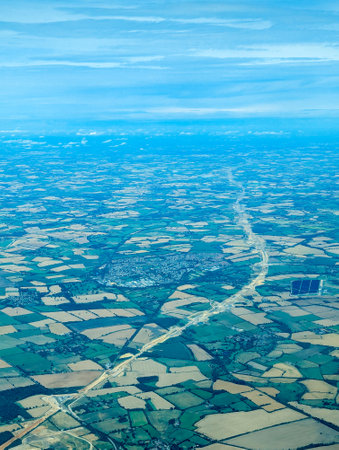 An aircraft flies over the route being laid for the HS2 train route between London and Birmingham. The controversial route has been canceled and shortened to save spending costs.の写真素材