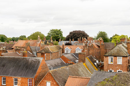 A view overlooking of a city or town, the view seeing hundreds of rooftops of various types of properties.の写真素材