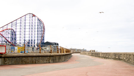 A rollercoaster is one of the best adrenaline junkie activities to do. Here seen a large rollercoaster structure with twists and turns for people to enjoy within a Theme Park.の写真素材