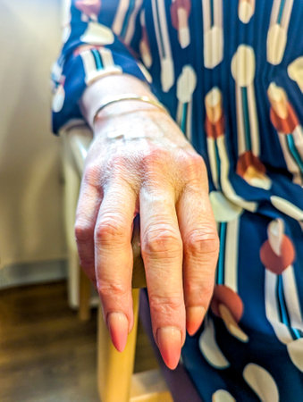 An adult female hand seen close up with the veins and skin that has lasted for many years.の写真素材