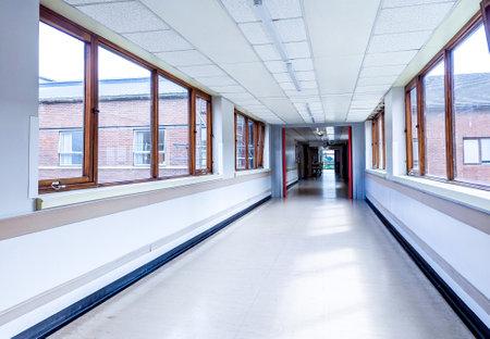 Patients and staff walk the corridors of a hospital to get to and from their appointment(s) or to visit their friends and family.の写真素材