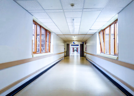 Patients and staff walk the corridors of a hospital to get to and from their appointment(s) or to visit their friends and family.の写真素材