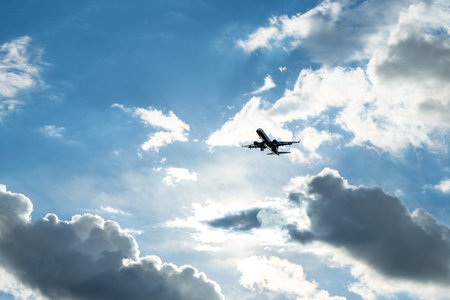 A passenger aircraft passing overhead as it either comes into land or has just taken off from an airport.の写真素材