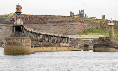 Whitby pier inlet is where boats of all types enter and exit the town's harbour to anchor and offload or onload goods and passengers.の写真素材
