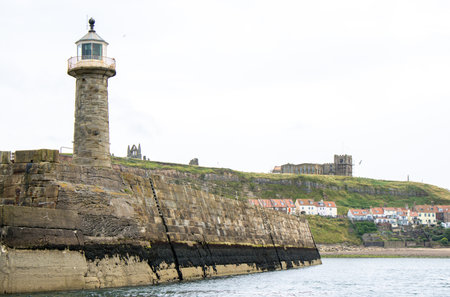 Whitby pier inlet is where boats of all types enter and exit the town's harbour to anchor and offload or onload goods and passengers.の写真素材