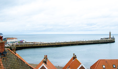 Whitby pier inlet is where boats of all types enter and exit the town's harbour to anchor and offload or onload goods and passengers.の写真素材