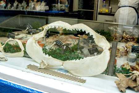 A seafood store where various types of seafood are being displayed and sold to customers, much like a butchers.の写真素材