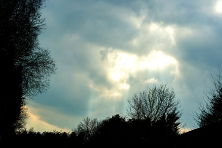 One of mother nature's beautiful spectacles with light beams lighting like a laser down to the ground from the skies above.の写真素材